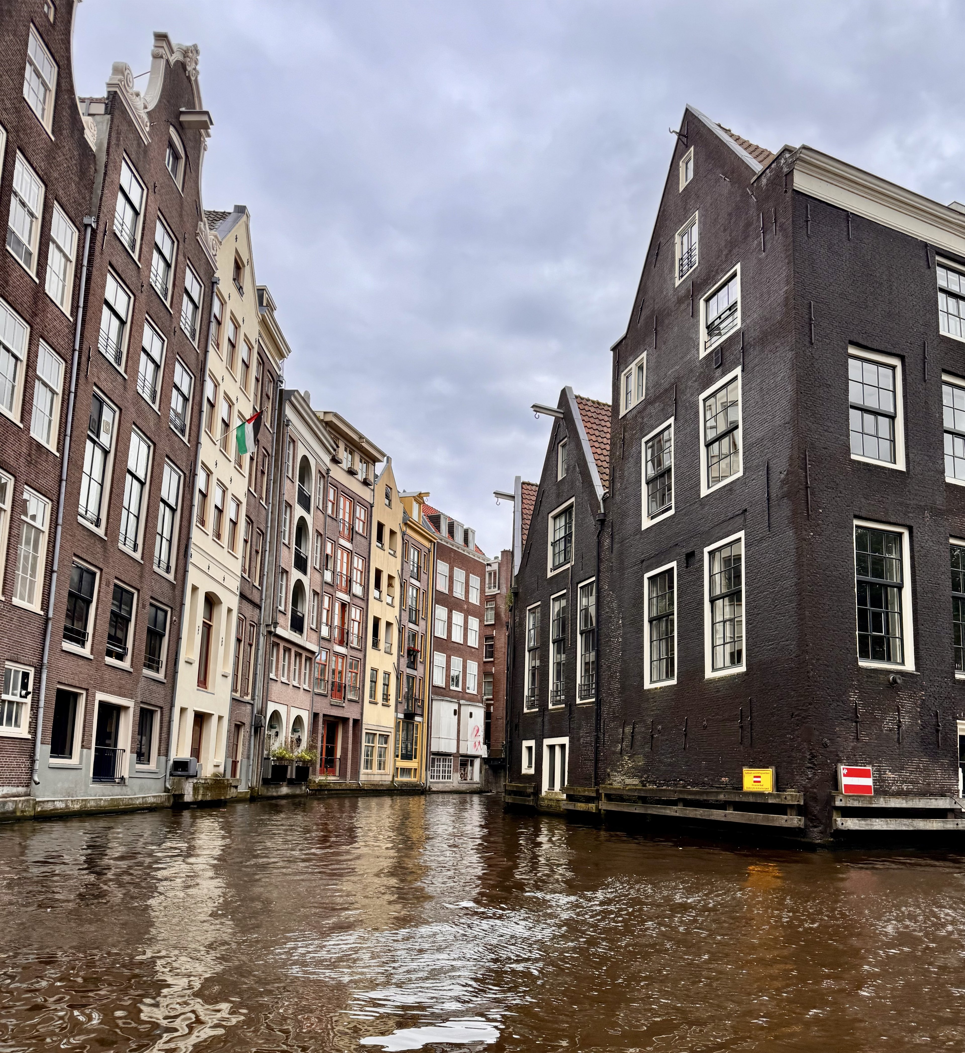 Canal cruise in Amsterdam, Holland with traditional Dutch canal houses lining the waterway